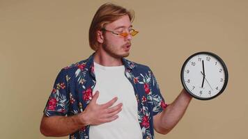 Confused man with anxiety checking time on clock, running late to work, being in delay, deadline video