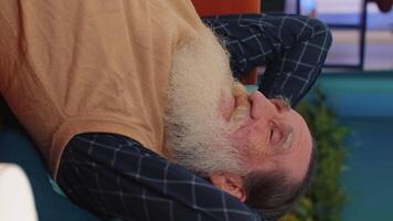 Tired one senior old man lying down in bed taking a rest at home, napping, falling asleep on sofa video