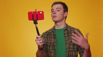 Man blogger take selfie on mobile phone selfie stick communicate call online with subscribers video