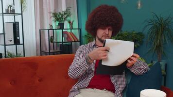 Man reading paper documents, reviewing reports, calculate costs, incomes, expenses, working at home video