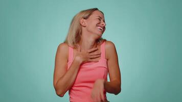 Woman pointing finger to camera, laughing out loud, making fun of ridiculous appearance, funny joke video