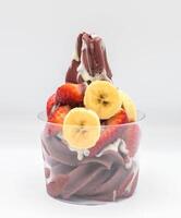 Yogurt and acai ice cream with chopped fruit pieces photo