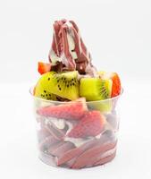 Yogurt and acai ice cream with chopped fruit pieces photo