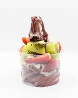 Yogurt and acai ice cream with chopped fruit pieces photo