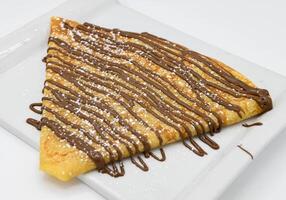 Pancakes with chocolate on a white background, close-up photo