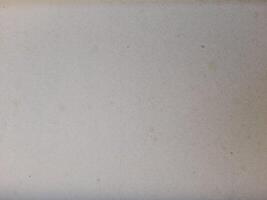 A blank sheet of white paper with a subtle texture and a few minor imperfections, likely dust or spots, is depicted in the image. photo