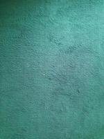 close-up of a teal fabric with a short, fuzzy pile. The fabric appears soft and textured, with a subtle sheen. photo