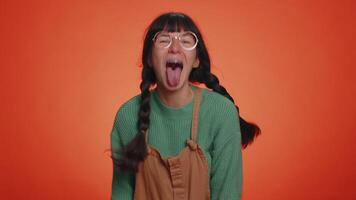 Funny joyful woman making playful silly facial expressions, grimacing, fooling around showing tongue video