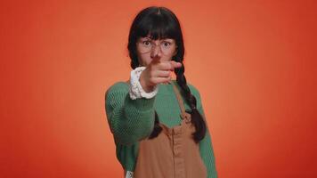 Young nerd woman smiling excitedly and pointing finger to camera, choosing lucky lottery winner video