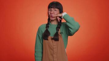 Young nerd woman looking at camera doing phone gesture like says hey you call me back, conversation video