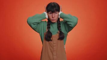 Annoyed irritated young woman covering ears, gesturing No avoiding advice ignoring noise loud voices video