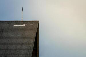 A view of a building with a roof, against a beautiful sky backdrop, showcasing architectural details and a clear, expansive horizon. Perfect for urban and architecture photography photo