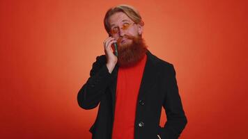 Tired sleepy man talking on mobile phone with friend, making online conversation annoyed boring talk video