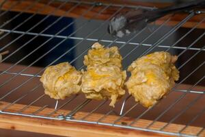 Gehu, a fried tofu and bean sprout snack, served at an angkringan. This crispy and savory Indonesian street food is a popular choice among locals and tourists photo