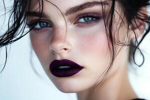 Minimalist Beauty Portrait with Dark Purple Matte Lips, Tousled Black Hair and Natural Makeup on Fair Complexion photo