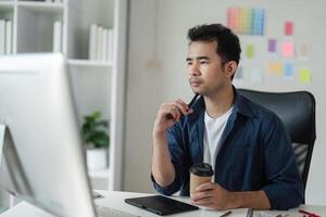 Focused Graphic Designer Strategizing a Creative Project in a Modern Office Environment with Digital Tools and Color Swatches photo