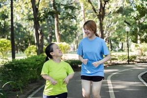 Young Woman with Physical Differences Exercising with Friend in Park, Promoting Inclusivity and Friendship through Fitness photo