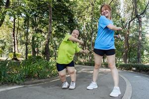 Young Women with Physical Differences Enjoying Outdoor Exercise Together in a Park Setting photo
