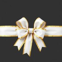 White ribbon with gold bow on black background photo