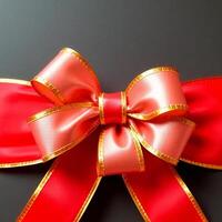 Red and gold bow on a black background photo
