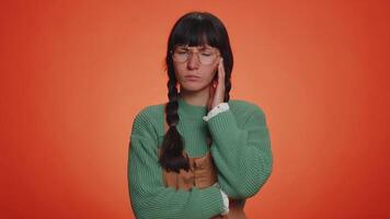 Thoughtful woman rubbing her chin and looking aside with pensive expression, pondering a solution video