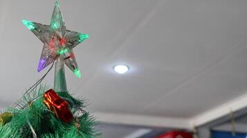 Christmas tree decoration with star top and colorful lights photo