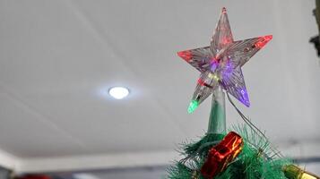 Christmas tree decoration with star top and colorful lights photo