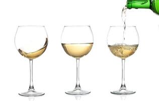 WHITE wine swirling in a goblet wine glass, isolated on a white background photo