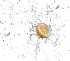 segment of lemon falling in to the water and making splash photo