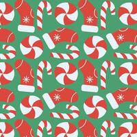 Seamless Christmas pattern with red socks and candy canes on green background. Festive design. vector