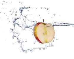 Apple in spray of water. Juicy apple with splash on white background photo