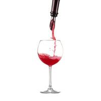 red wine pouring into wine glass isolated photo