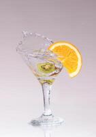 cocktail in a martini glass on a white background with fruit photo