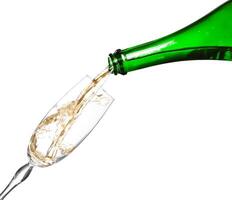 Champagne being poured into glass or flute, isolated on a white background. photo