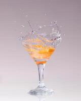 cocktail in a martini glass on a white background with fruit photo