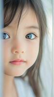 Young child gazing thoughtfully with bright blue eyes in soft natural light photo