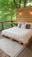 Cozy outdoor bed setup surrounded by strings of lights and greenery in a tranquil setting photo