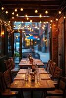Cozy outdoor dining area illuminated by string lights at a restaurant in the evening photo