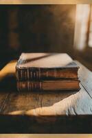 A simple, closed book resting on a rustic wooden stool in a sunlit room with a window photo