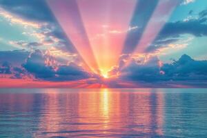 A serene sunset over calm waters with vibrant pink and blue clouds reflecting on the ocean photo
