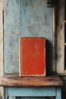 An old leather bound book resting on a rustic wooden table in a weathered space photo