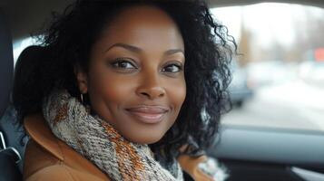 Young woman smiling joyfully inside a car during a bright day in a city environment photo