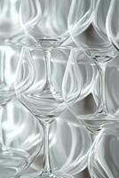 Colorful glasses arranged artistically on a table showcasing vibrant hues in bright light photo