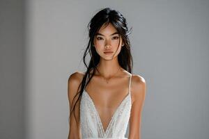 Elegant model walks the runway wearing a stunning white gown during a fashion show photo