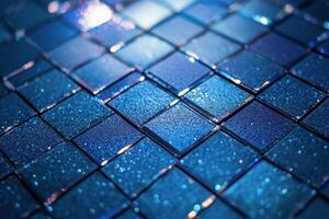 Close up view of shimmering blue tiles arranged in a square pattern on a wall photo