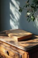 A vintage book resting on a wooden table beside a weathered blue door in afternoon light photo