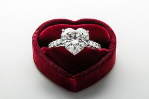 Beautiful heart shaped diamond ring in a red velvet jewelry box on a light background photo