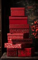 A stack of beautifully designed red gift boxes with intricate patterns in a cozy setting photo