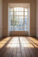 Sunlight streaming through French doors in a rustic room with wooden floors during autumn photo