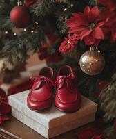 Red holiday shoes placed under a Christmas tree surrounded by ornaments and gifts in a warm setting photo